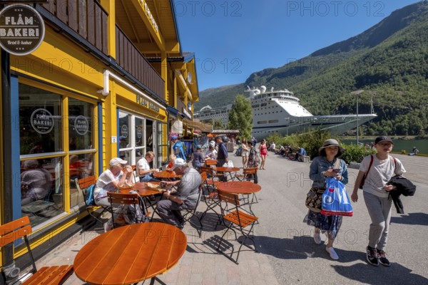Tourists in Flåm, FABRIK KUTSALG FACTORY OUTLET, café, yellow wooden house, excursion ship, fjord,