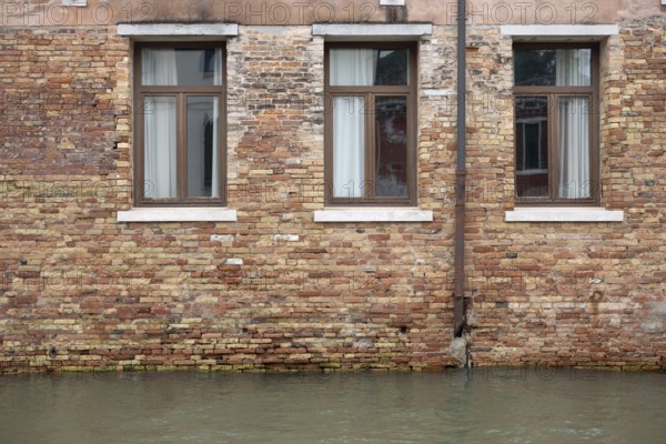 Venice, Italy - 2 September 2025: The water in a canal is seen in front of a hotel during the 82nd