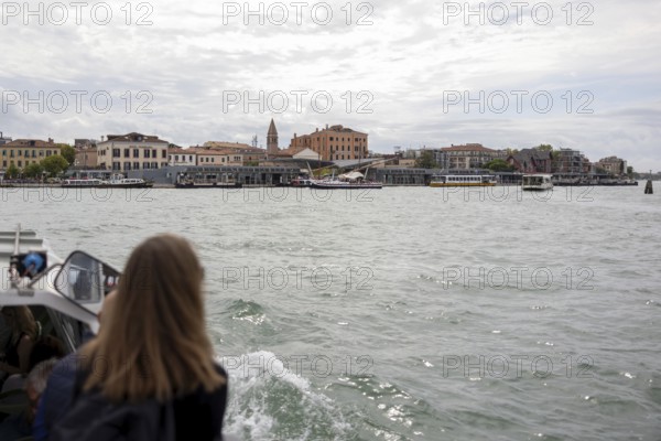 Venice, Italy - 2 September 2025: A woman takes a photo with her mobile phone on the way to the