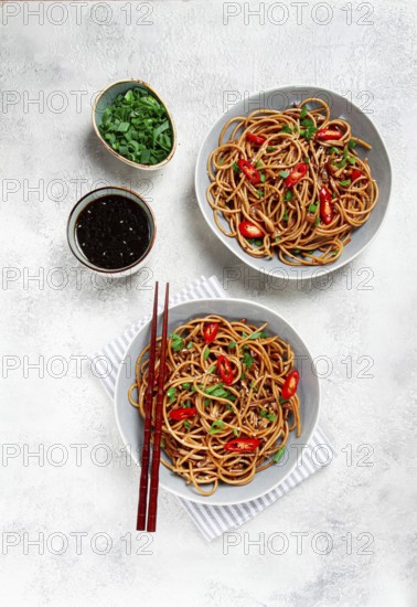 Udon noodles, with shimeji mushrooms, vegetables, in sauce, with sesame seeds, green onions, Asian