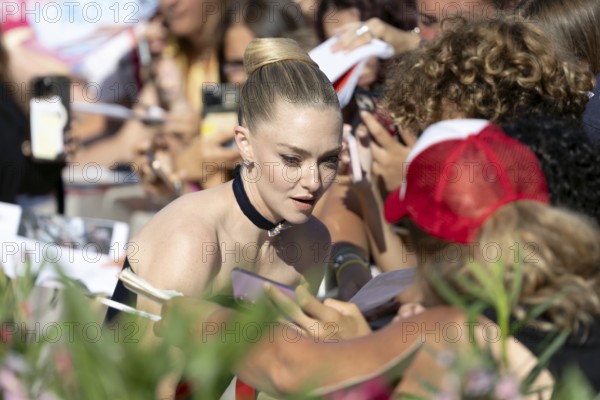 Venice, Italy - 1 September 2025: Amanda Seyfried signing autographs during the Red Carpet of - The