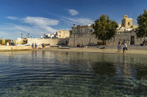 City beach Spiaggetta del Molo or Spiaggia dei Bambini and the old town centre of Otranto, Apulia,