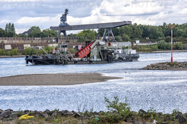 Bucket chain dredger at work on the Rhine near Duisburg, between the Neuenkamper Rhine Bridge and