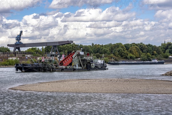 Bucket chain dredger at work on the Rhine near Duisburg, between the Neuenkamper Rhine Bridge and
