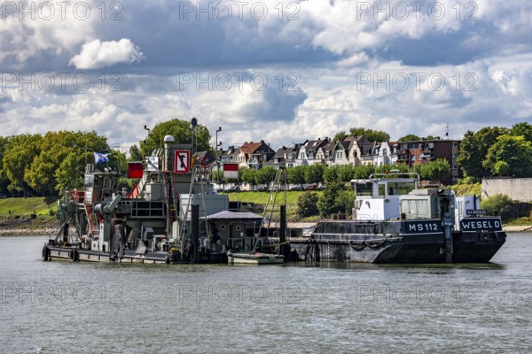 Bucket chain dredger at work on the Rhine near Duisburg, between the Neuenkamper Rhine Bridge and