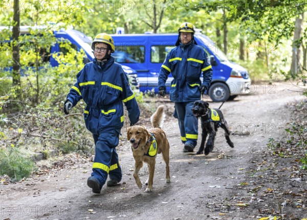 Dog handlers with rescue dogs from the Specialist Locating Group get ready for action, the sniffer