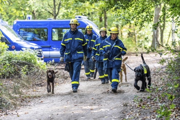 Dog handlers with rescue dogs from the Specialist Locating Group get ready for action, the sniffer