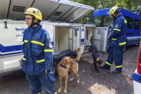 Dog handlers with rescue dogs from the Specialist Locating Group get ready for action, the sniffer