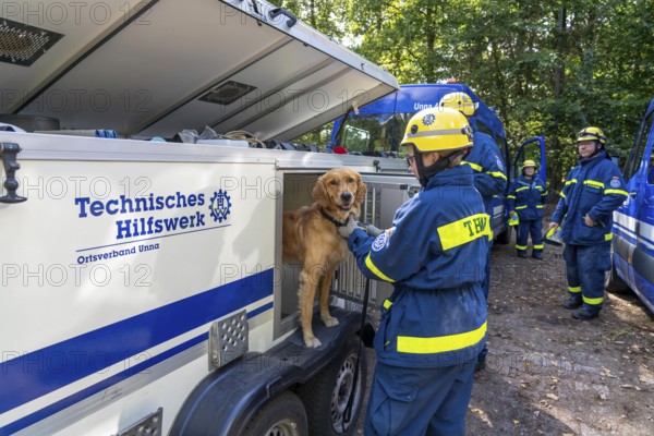 Dog handlers with rescue dogs from the Specialist Locating Group get ready for action, the sniffer