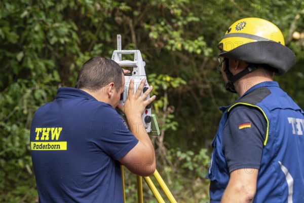 Surveying experts constructing a façade support for a building in danger of collapsing, using the