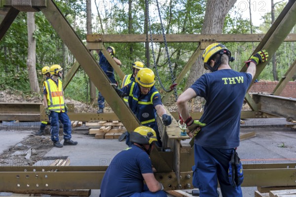 Construction of a temporary bridge over a slipped road crossing a stream, by the bridge