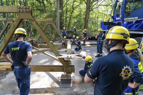 Construction of a temporary bridge over a slipped road crossing a stream, by the bridge