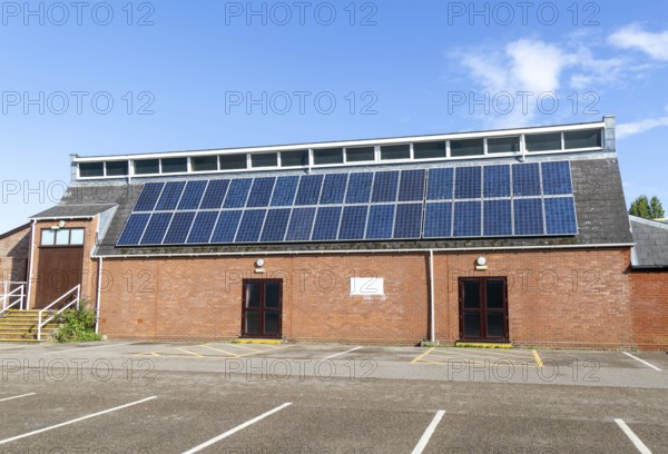 Solar panels on roof of Woodbridge Community Hall, community centre building, Woodbridge, Suffolk,