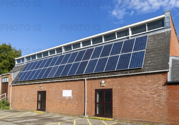 Solar panels on roof of Woodbridge Community Hall, community centre building, Woodbridge, Suffolk,
