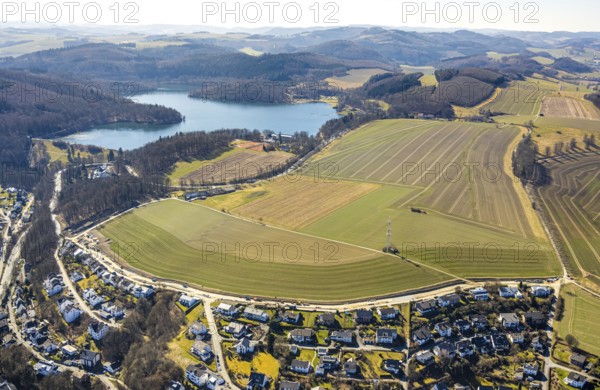 Aerial view, Hennesee dam with wooded area and hilly landscape, meadows and fields with residential