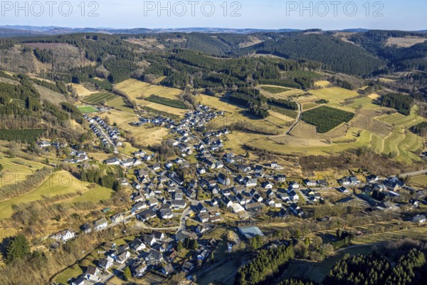 Aerial view, residential area town centre with St. Katharina Catholic Church, wooded area hilly