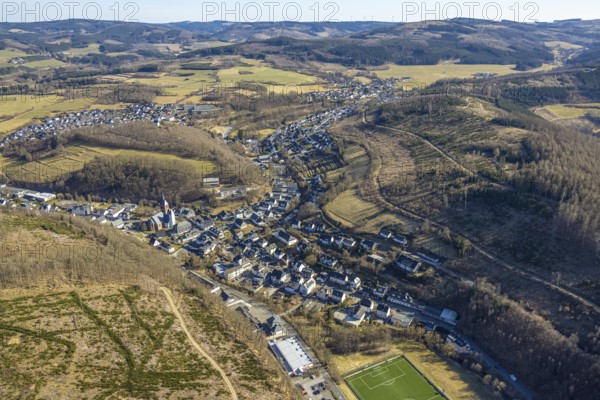 Aerial view, residential area local view, wooded area hilly landscape with forest damage, Church of