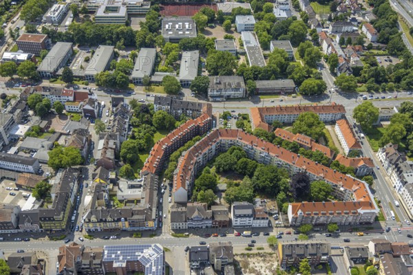 Aerial view, residential complex with red roofs and green trees in the inner courtyard on
