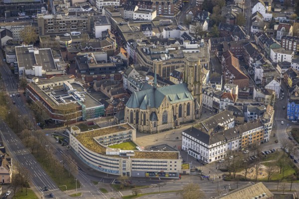 Aerial view, St. Urbanus Catholic Church and church square, commercial buildings and shopping