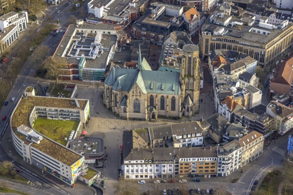 Aerial view, St. Urbanus Catholic Church and church square, commercial buildings and shopping