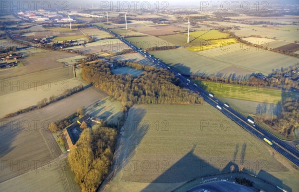 Aerial view, motorway A2, meadows and fields with wind turbines, distant view to the industrial