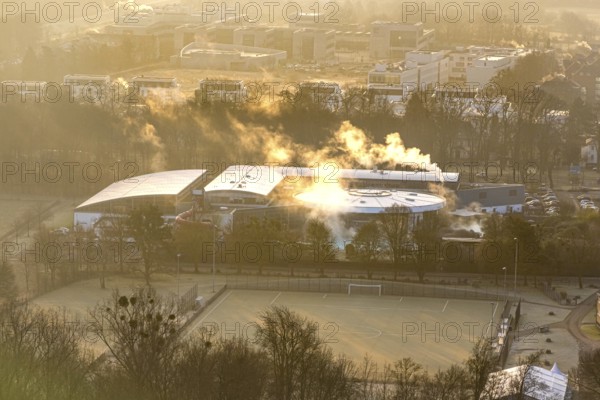 Aerial view, wintry Maximare adventure pool with indoor and outdoor pools with clouds of smoke, in