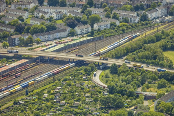 Aerial view, railway line with container site and bridge Friedrich-Ebert-Straße with curved road