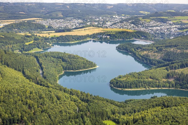 Aerial view, Hennesee dam surrounded by forest, Welcome Hotel and view to Meschede, sailing boat on