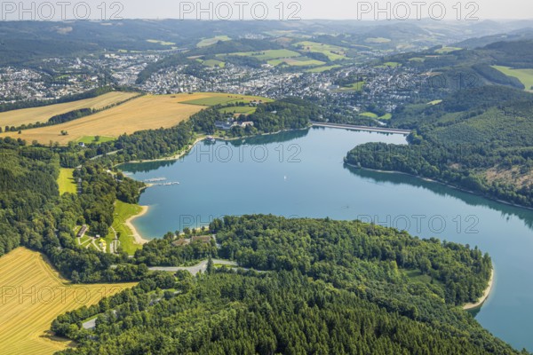 Aerial view, Hennesee dam surrounded by forest, Welcome Hotel and view to Meschede, sailing boat on