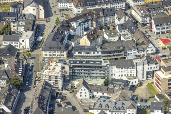 Aerial view, construction site with construction crane and new residential building on the corner