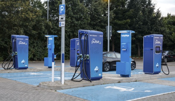Charging stations with charging plugs at ARAl Pulse, Blankenfelde, 26/08/2025. A Tesla being