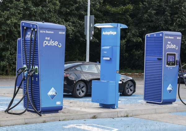 Charging stations with charging plugs at ARAl Pulse, Blankenfelde, 26/08/2025. A Tesla being