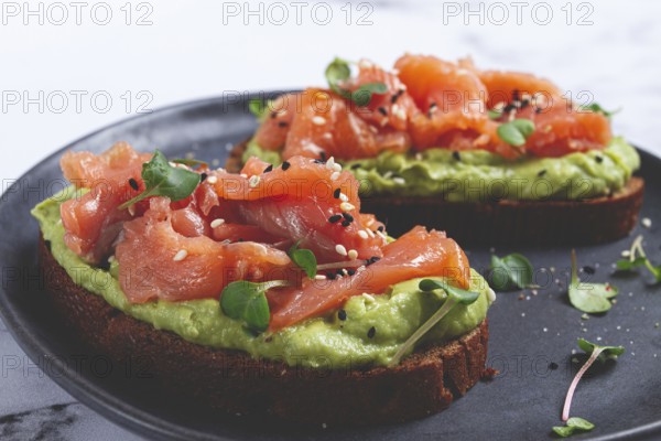 Breakfast, Sandwiches with smoked salmon and avocado, on dark rye bread, with microgreens, on a