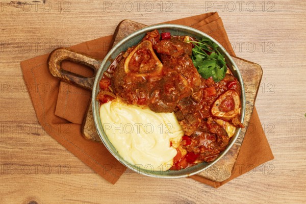 Ossobuco, stewed meat knuckle on the bone, with mashed potatoes, and oats and spices, homemade, no