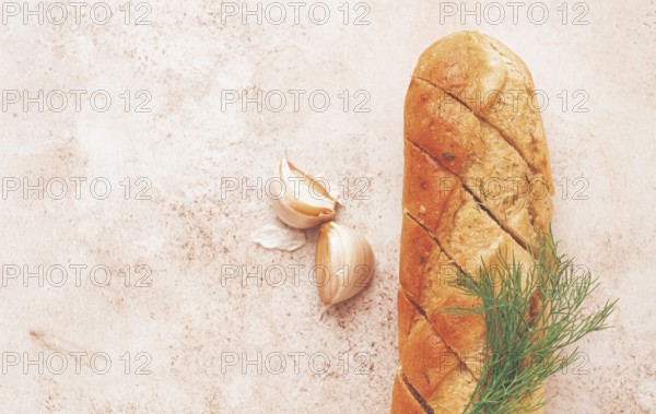 Freshly baked garlic bread with herbs and garlic on a light countertop