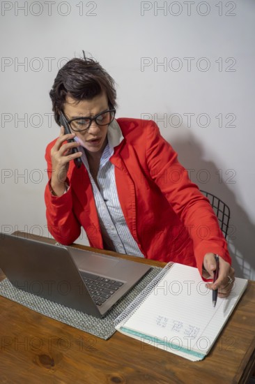 Focused businesswoman writing down important details from a call