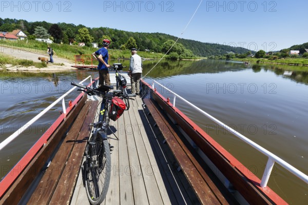 Cyclist on yaw rope ferry, passenger ferry on the Weser, from Herstelle to Würgassen, Beverungen,