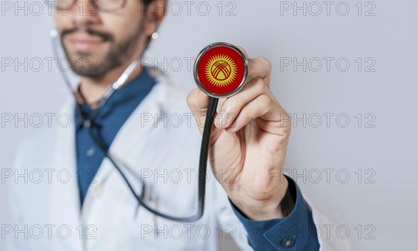 Doctor holding stethoscope with Kyrgyzstan flag. Kyrgyzstan health and care concept, Kyrgyzstan