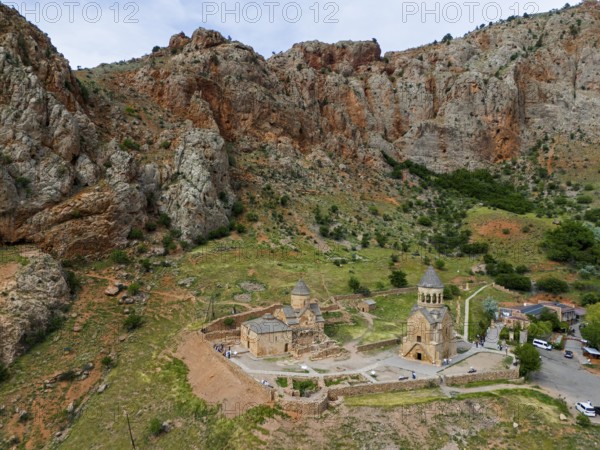 Historic churches embedded in a rocky mountain landscape, surrounded by green vegetation and