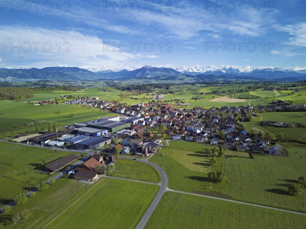 View of the village, in the foreground the industrial area, in the background the Rigi and the