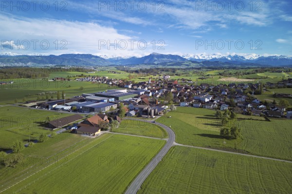 View of the village, in the foreground the industrial area, in the background the Rigi and the