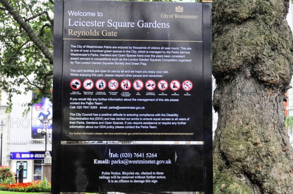 Information sign with park rules and prohibitions in Leicester Square Gardens, Westminster, London,