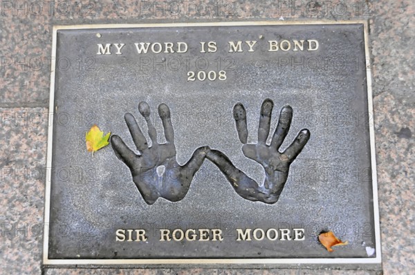 Plaque with handprints and the inscription by Sir Roger Moore, My Word Is My Bond 2008, London,