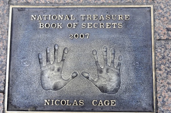 Nicolas Cage's handprints for National Treasure on a metal plate on the pavement, London, England,
