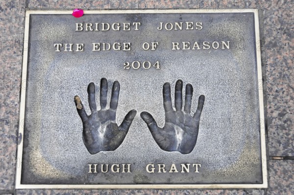 Handprints of Hugh Grant for the film Bridget Jones on a metal plate on the pavement, London,