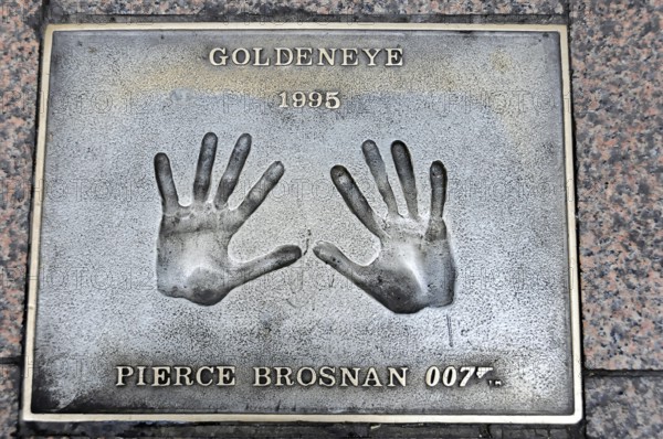 Handprints of Pierce Brosnan for the film GoldenEye on a metal plate on the pavement, London,