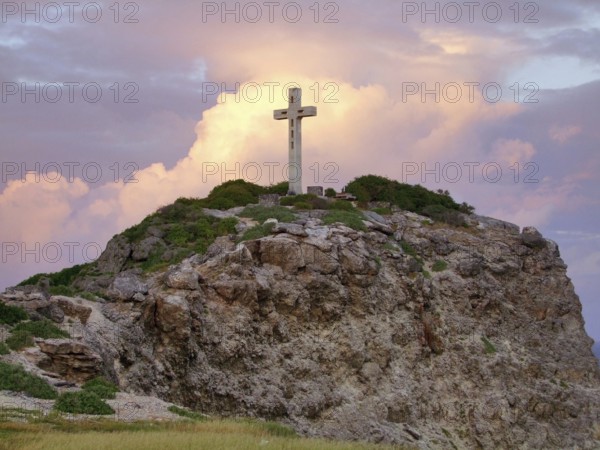 Colorful sundown scenery on a caribbean island named Guadeloupe including a summit cross on