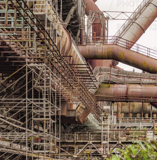 Weathered rusty industrial scenery with old corroded steel girders and metal tubes