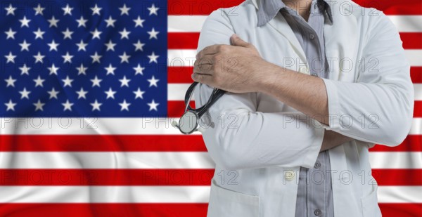 Doctor with stethoscope on arm with American flag behind. National health system of United States,