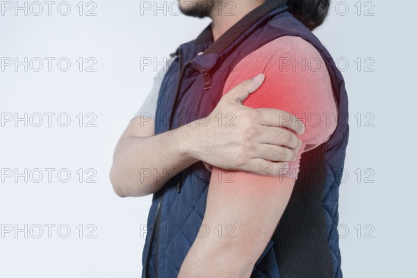 Unrecognizable person with shoulder pain on isolated. Person in pain with arm pain highlighted in